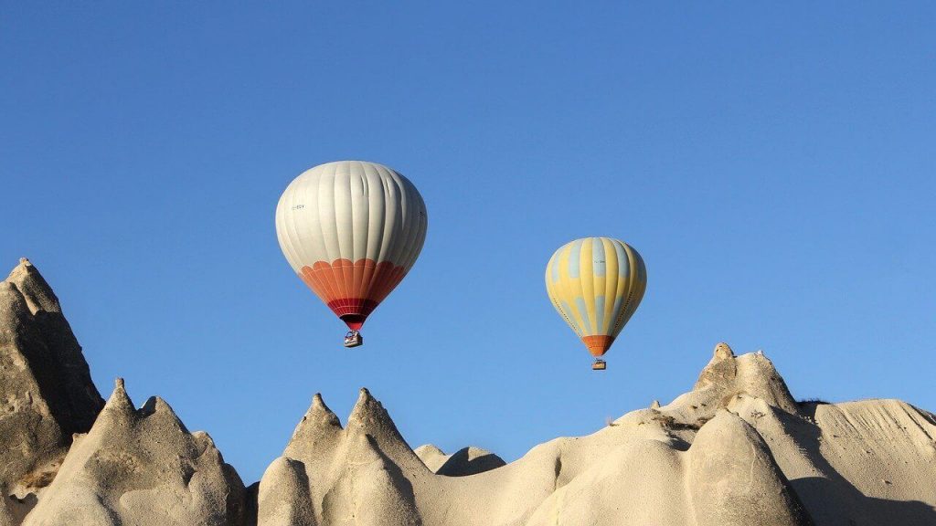Hot air balloons over sand dunes